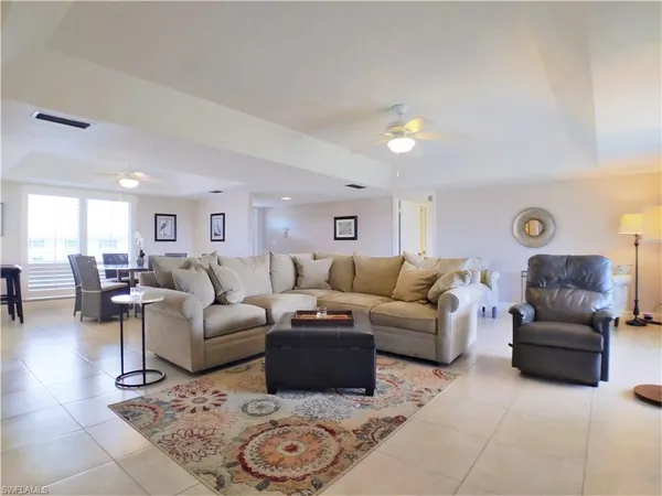 a living room with furniture and view of kitchen