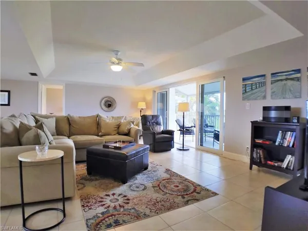 a living room with furniture a rug and a window