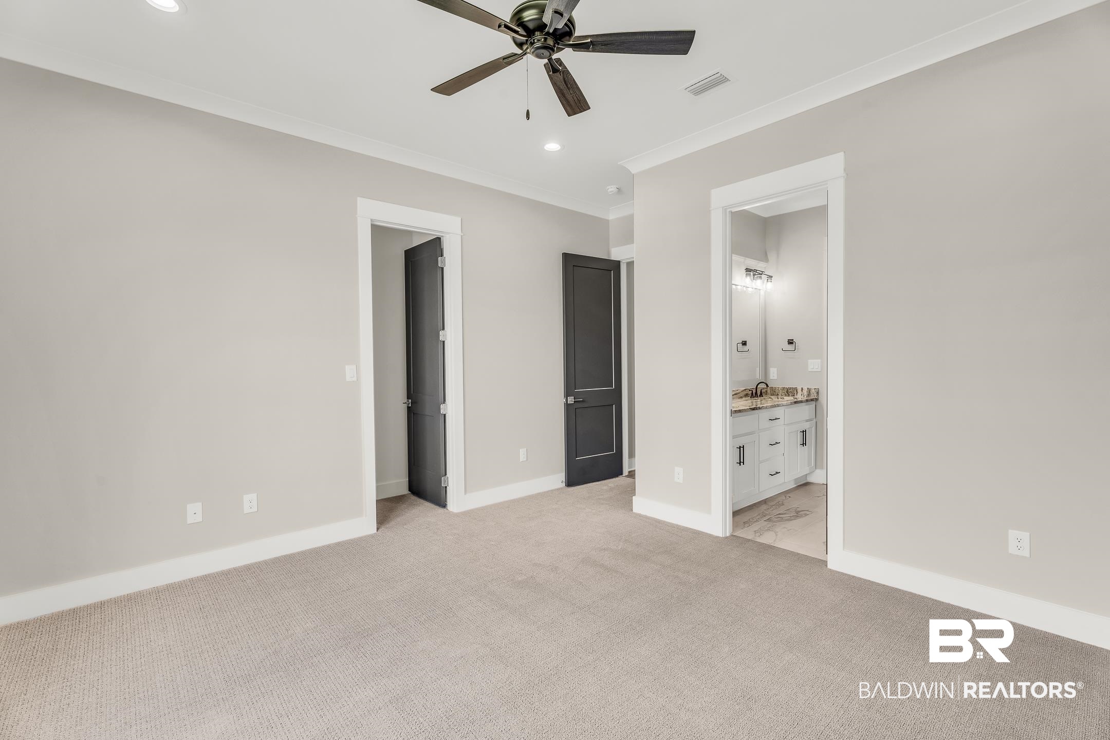17786 Burwick Loop Fairhope, AL 36532 - Photo 44 of 57 Unfurnished bedroom with ensuite bath, sink, light colored carpet, crown molding, and ceiling fan