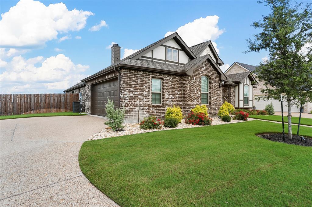 1904 Angelus Street Waco, TX 76712 - Photo 2 of 24 View of front facade featuring brick siding, roof with shingles, concrete driveway, a garage, and a chimney
