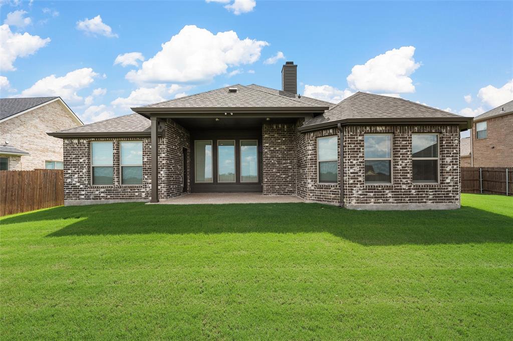 1904 Angelus Street Waco, TX 76712 - Photo 22 of 24 Back of house with brick siding, roof with shingles, a patio area, and a chimney