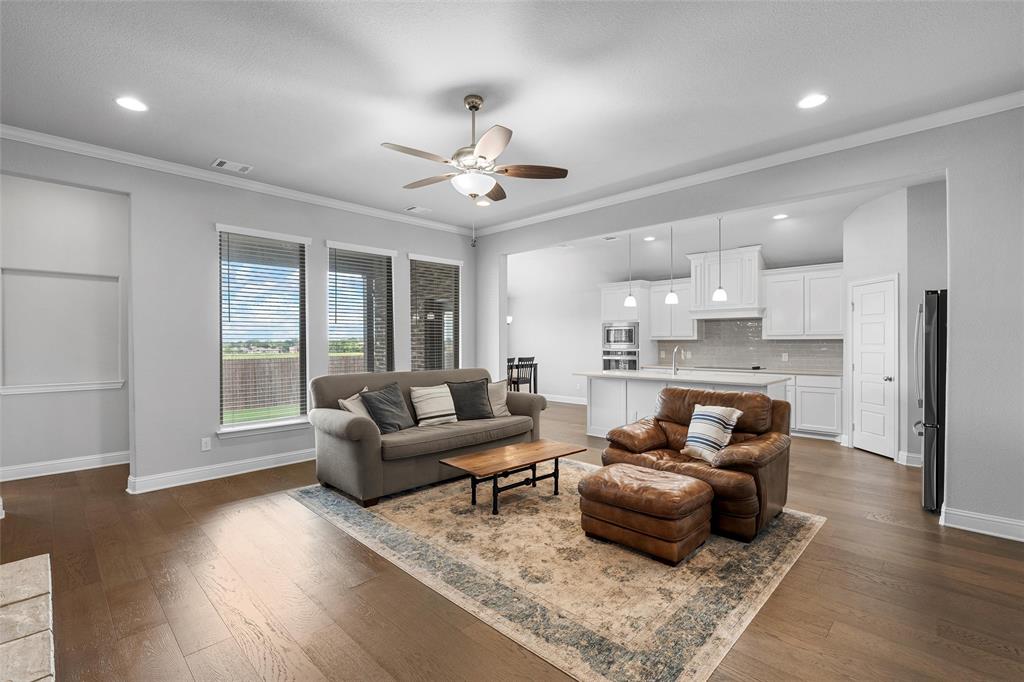 1904 Angelus Street Waco, TX 76712 - Photo 4 of 24 Living room featuring a ceiling fan, dark wood-type flooring, ornamental molding, and recessed lighting
