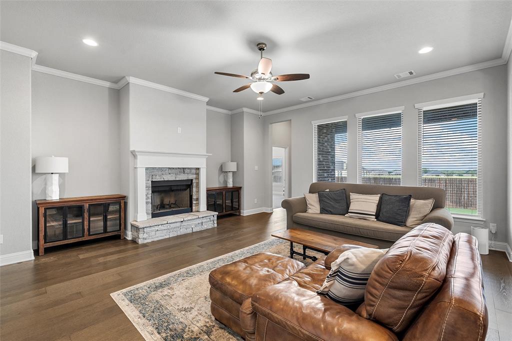 1904 Angelus Street Waco, TX 76712 - Photo 5 of 24 Living room featuring a ceiling fan, wood finished floors, recessed lighting, a fireplace, and crown molding