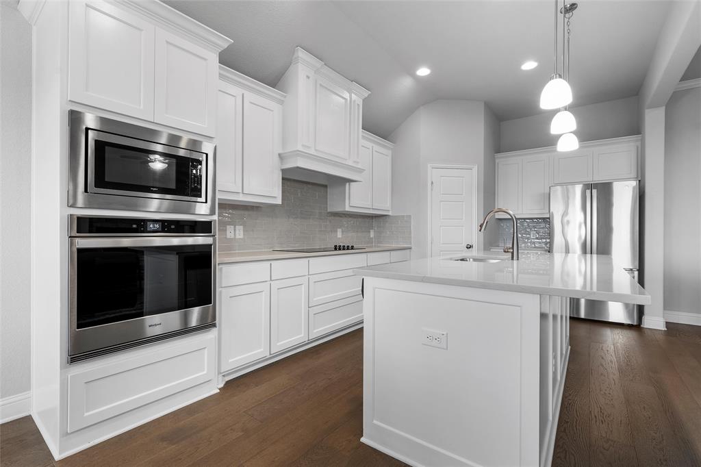 1904 Angelus Street Waco, TX 76712 - Photo 9 of 24 Kitchen featuring appliances with stainless steel finishes, light countertops, tasteful backsplash, white cabinets, and lofted ceiling
