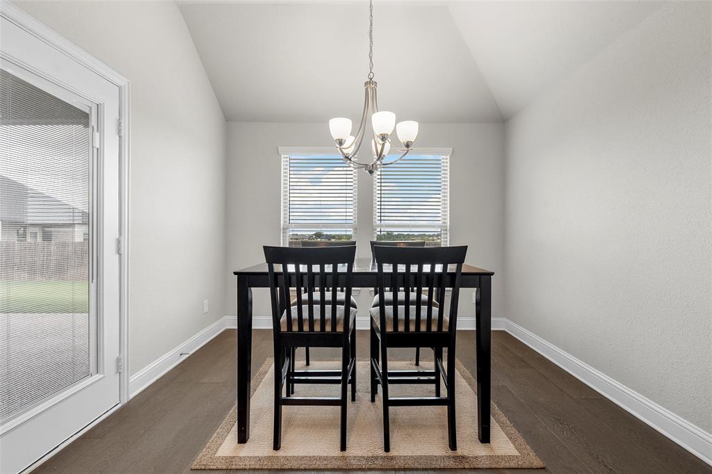 1904 Angelus Street Waco, TX 76712 - Photo 10 of 24 Dining space with a chandelier, dark wood-type flooring, and vaulted ceiling