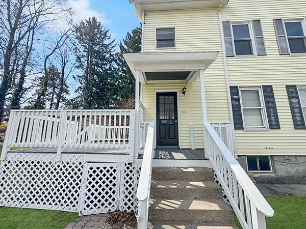 a view of a house with wooden deck