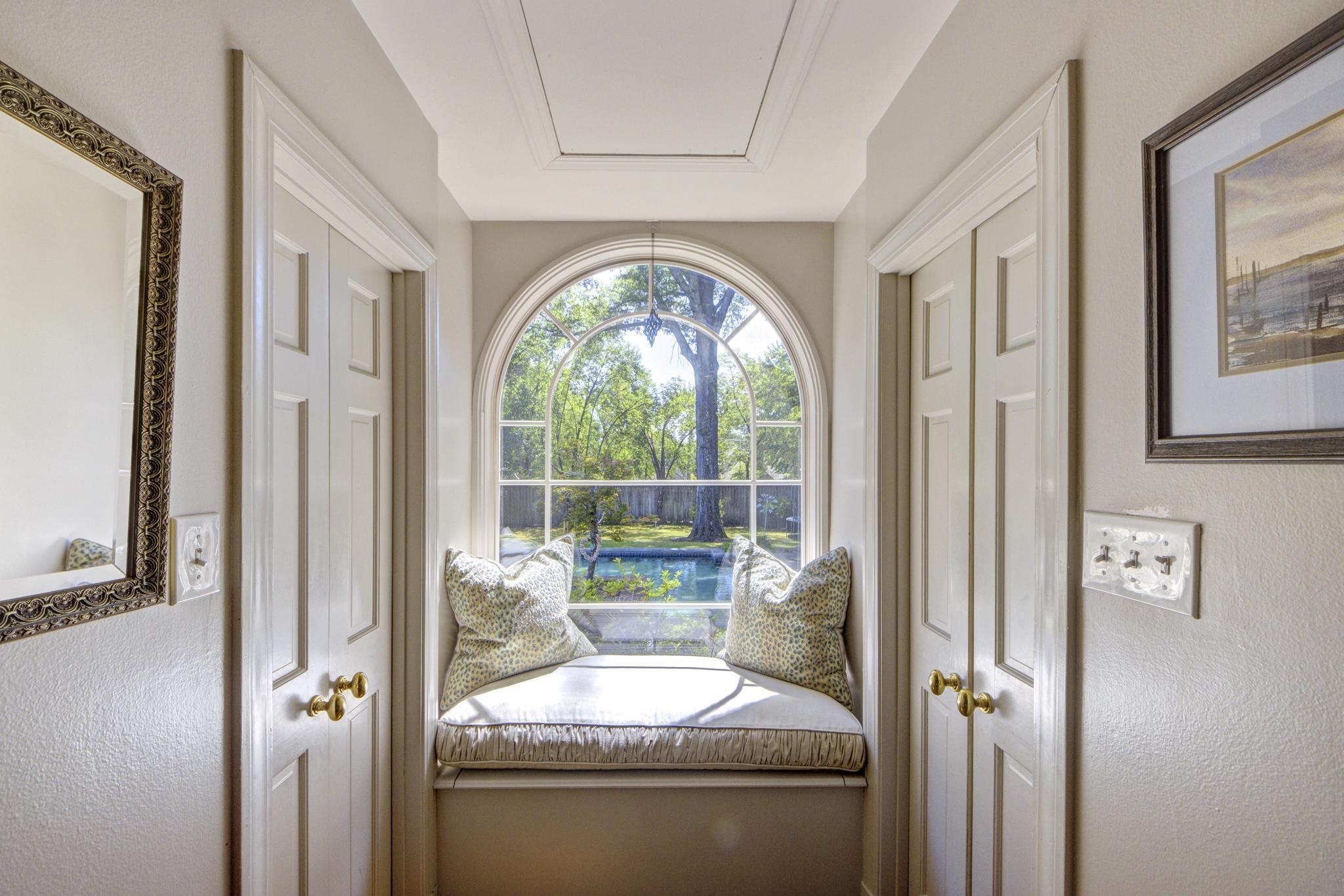 370 Greenway Road Memphis, TN 38117 - Photo 18 of 40 Primary suite window seat overlooking the Pool and Grounds is flanked by His and Her Walk-in Closets.