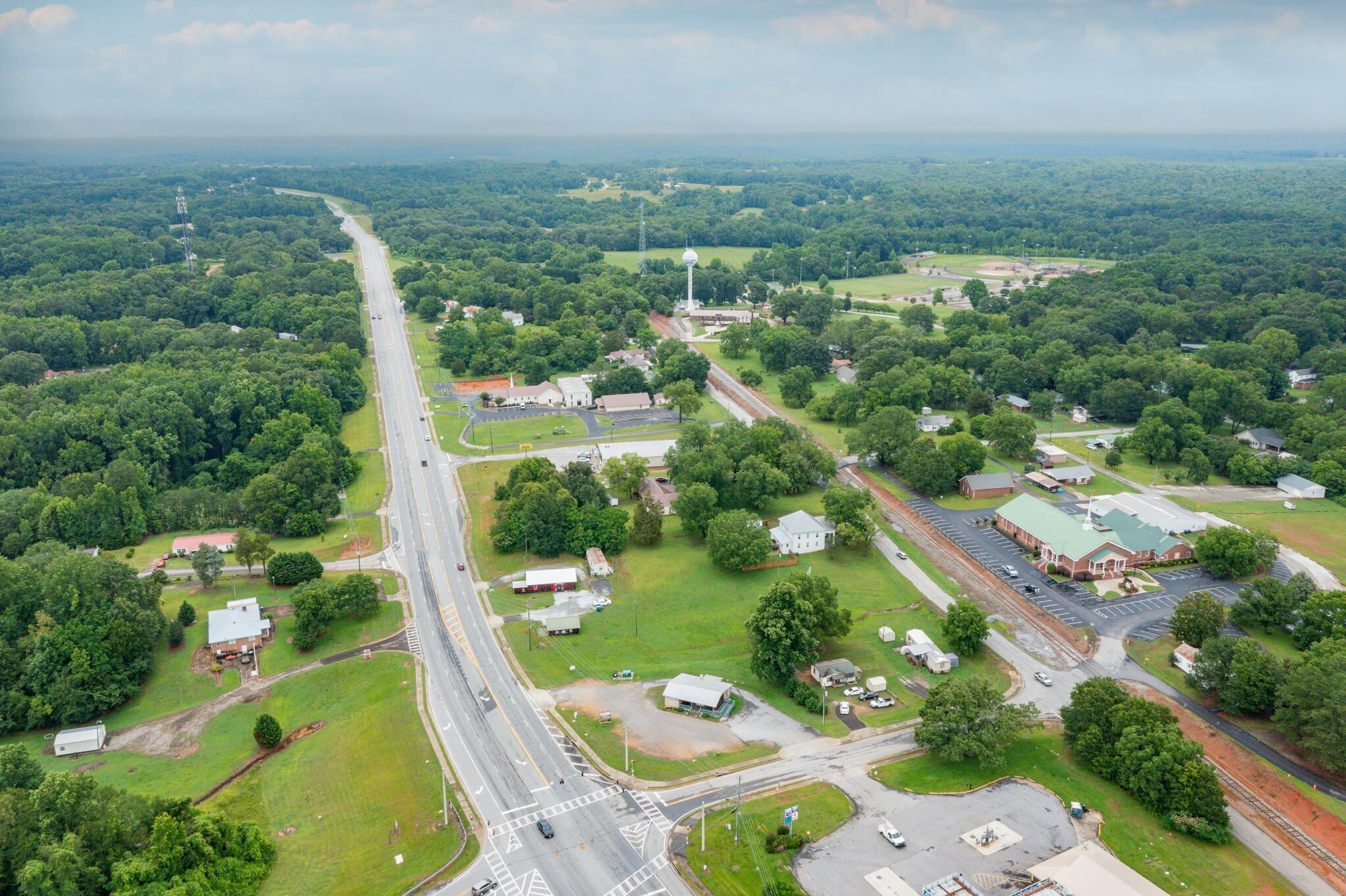 an aerial view of a residential houses with outdoor space and street view