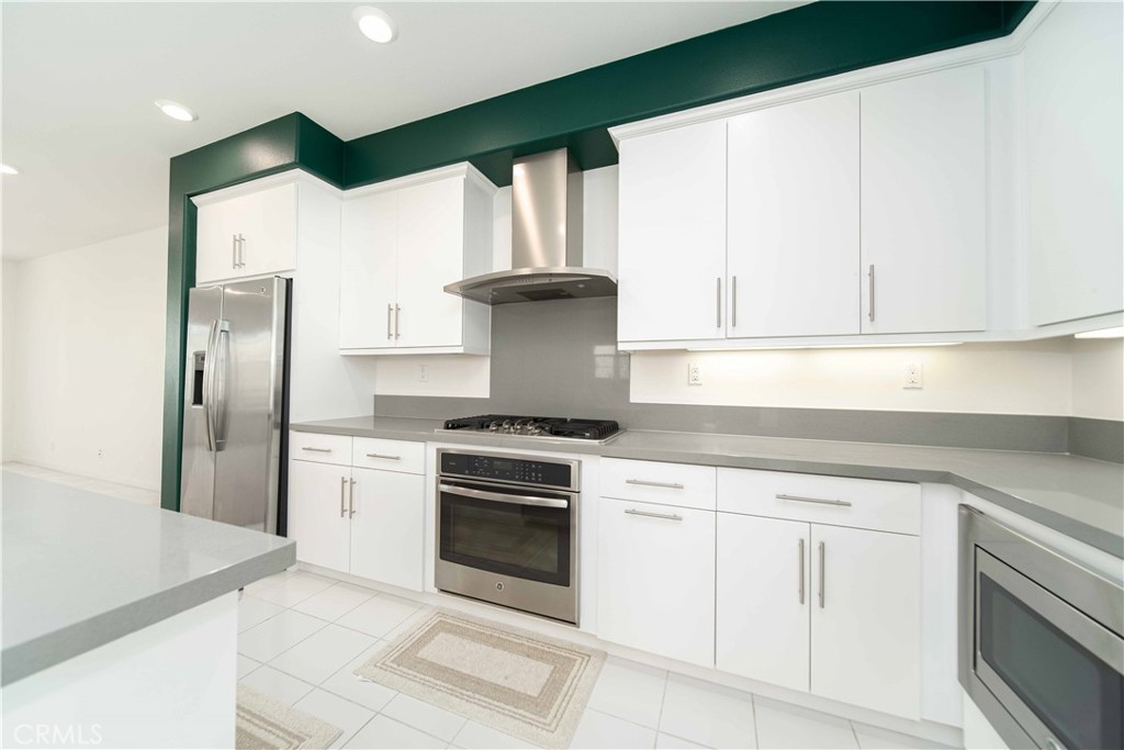 134 Acamar Irvine, CA 92618 - Photo 16 of 56 a kitchen with white cabinets and appliances