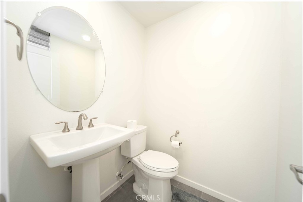 134 Acamar Irvine, CA 92618 - Photo 17 of 56 a bathroom with a sink a mirror and toilet