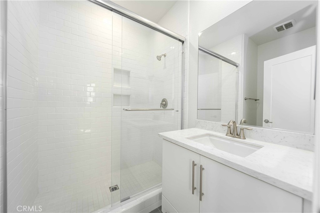 134 Acamar Irvine, CA 92618 - Photo 21 of 56 a bathroom with a shower sink vanity and mirror