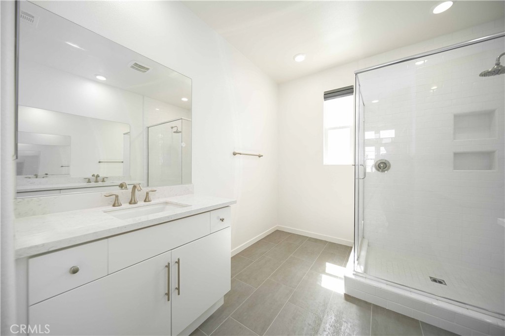 134 Acamar Irvine, CA 92618 - Photo 26 of 56 a spacious bathroom with a shower sink and mirror