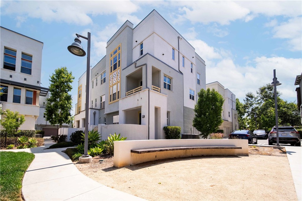 134 Acamar Irvine, CA 92618 - Photo 35 of 56 a view of a building with potted plants and a yard