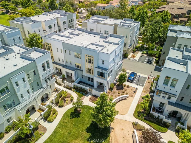 an aerial view of residential houses with outdoor space
