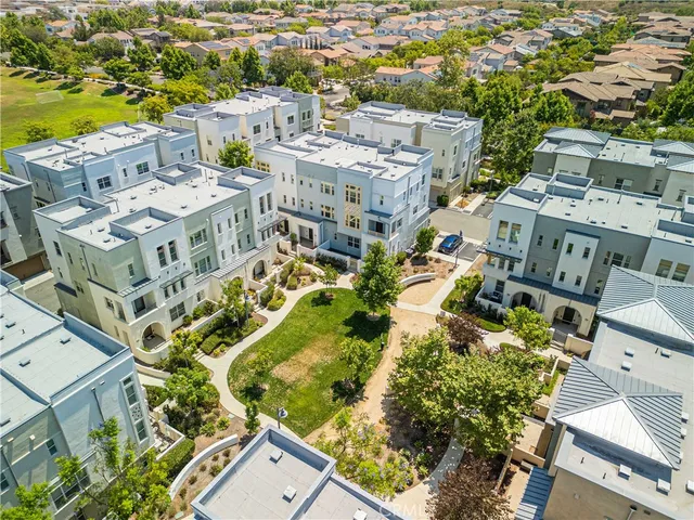 an aerial view of residential houses with outdoor space