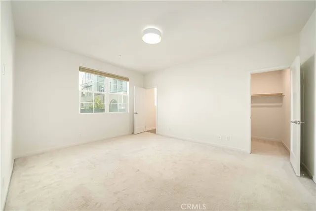 an empty room with cabinet and mirrors