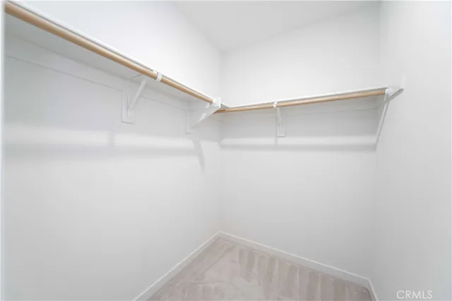 a view of staircase with white walls and a window