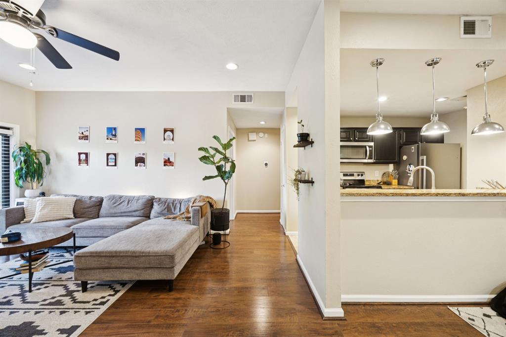 a living room with furniture and kitchen view