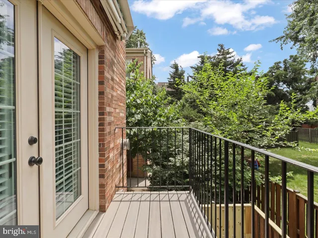 a view of balcony with wooden floor and fence