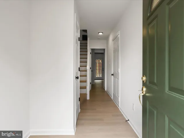 a view of hallway with wooden floor