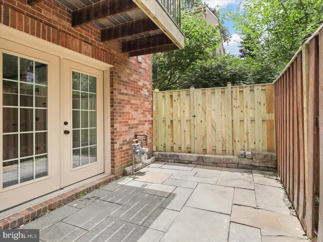 a view of a pathway with a wooden fence