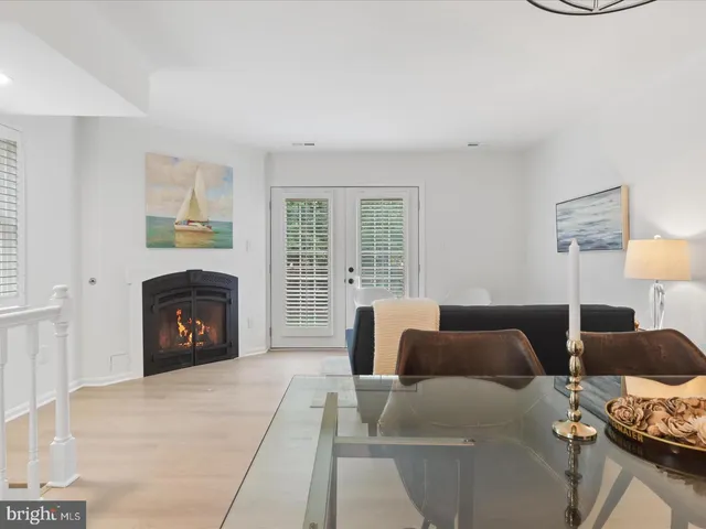 a living room with furniture a fireplace and a table