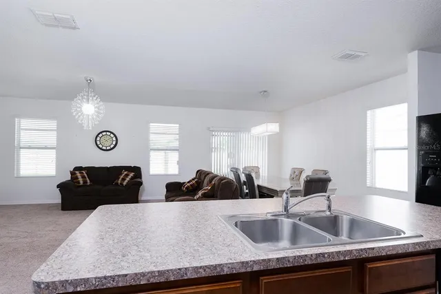 a view of a kitchen counter space and windows