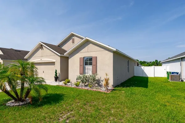 a view of a house with a yard and a garden