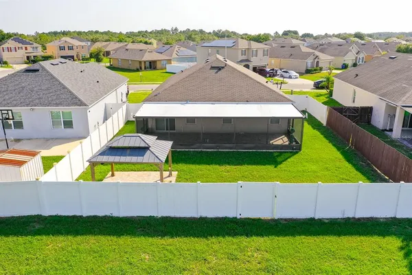 an aerial view of a house with a big yard and large trees