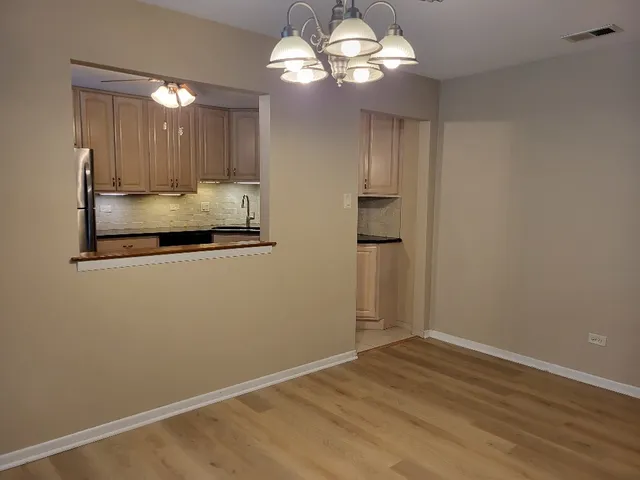 a kitchen with stainless steel appliances granite countertop a refrigerator a stove a sink and dishwasher