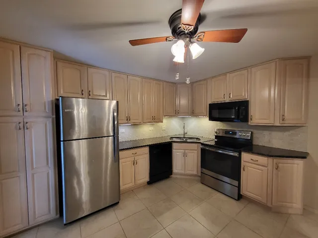 a kitchen with a sink and a refrigerator