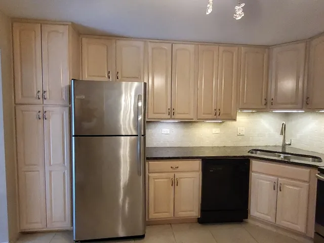 a view of a refrigerator in kitchen
