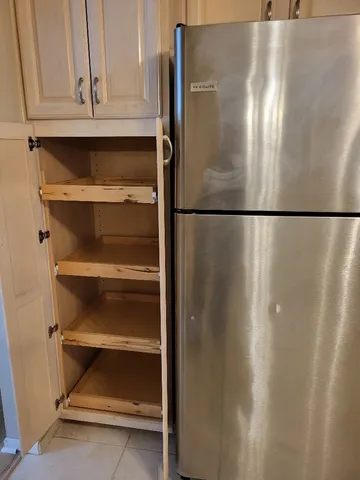 a kitchen with a refrigerator stove and cabinets