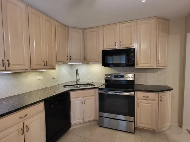 a kitchen with stainless steel appliances a sink and cabinets