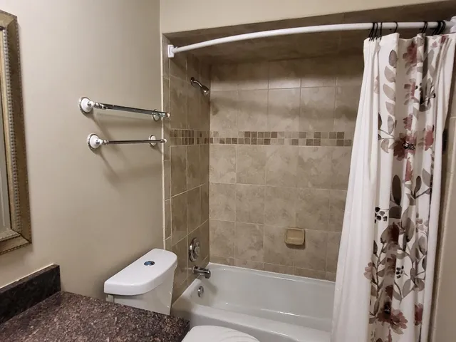 a bathroom with a bathtub and a shower