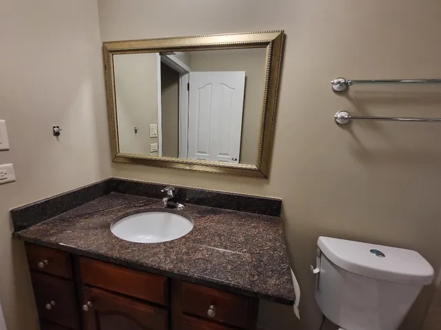 an empty room with windows and ceiling fan