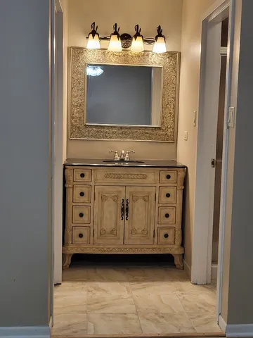 a bathroom with a sink and a mirror