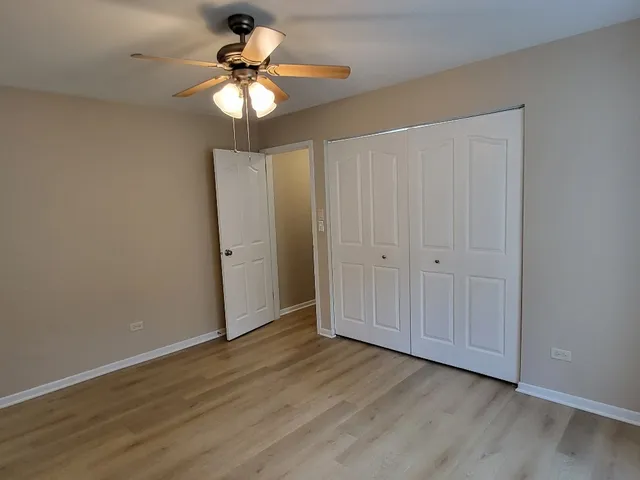 a view of walk in closet with wooden floor