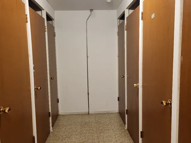 a front view of a brick house with a yard and a garage