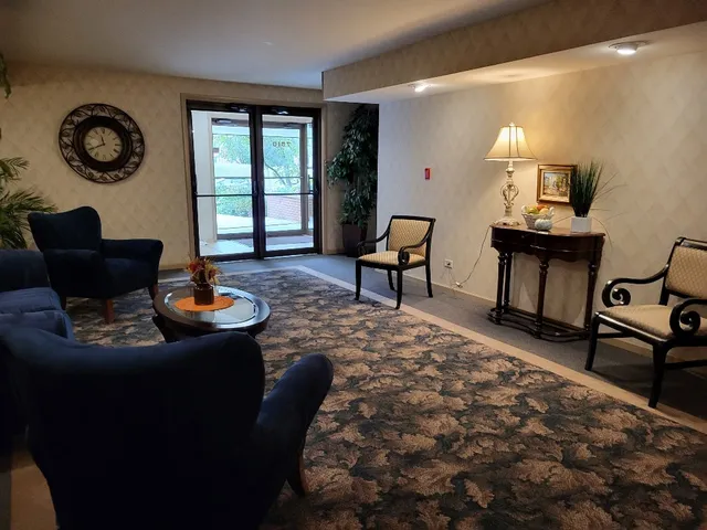 a living room with furniture and a piano
