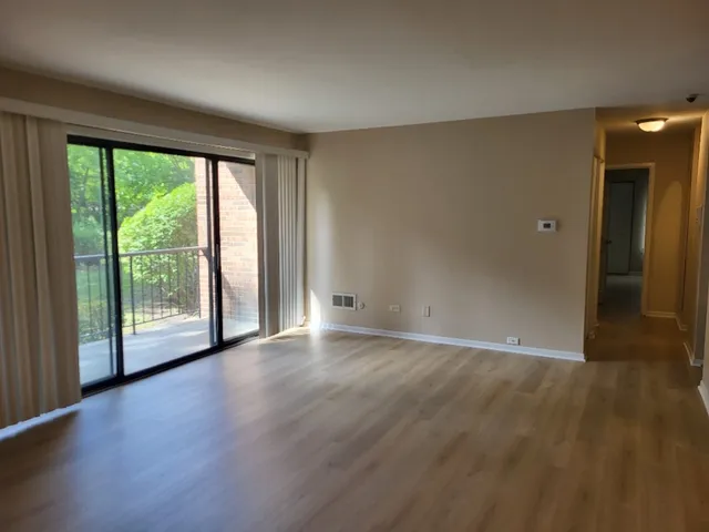 a view of a room with wooden floor