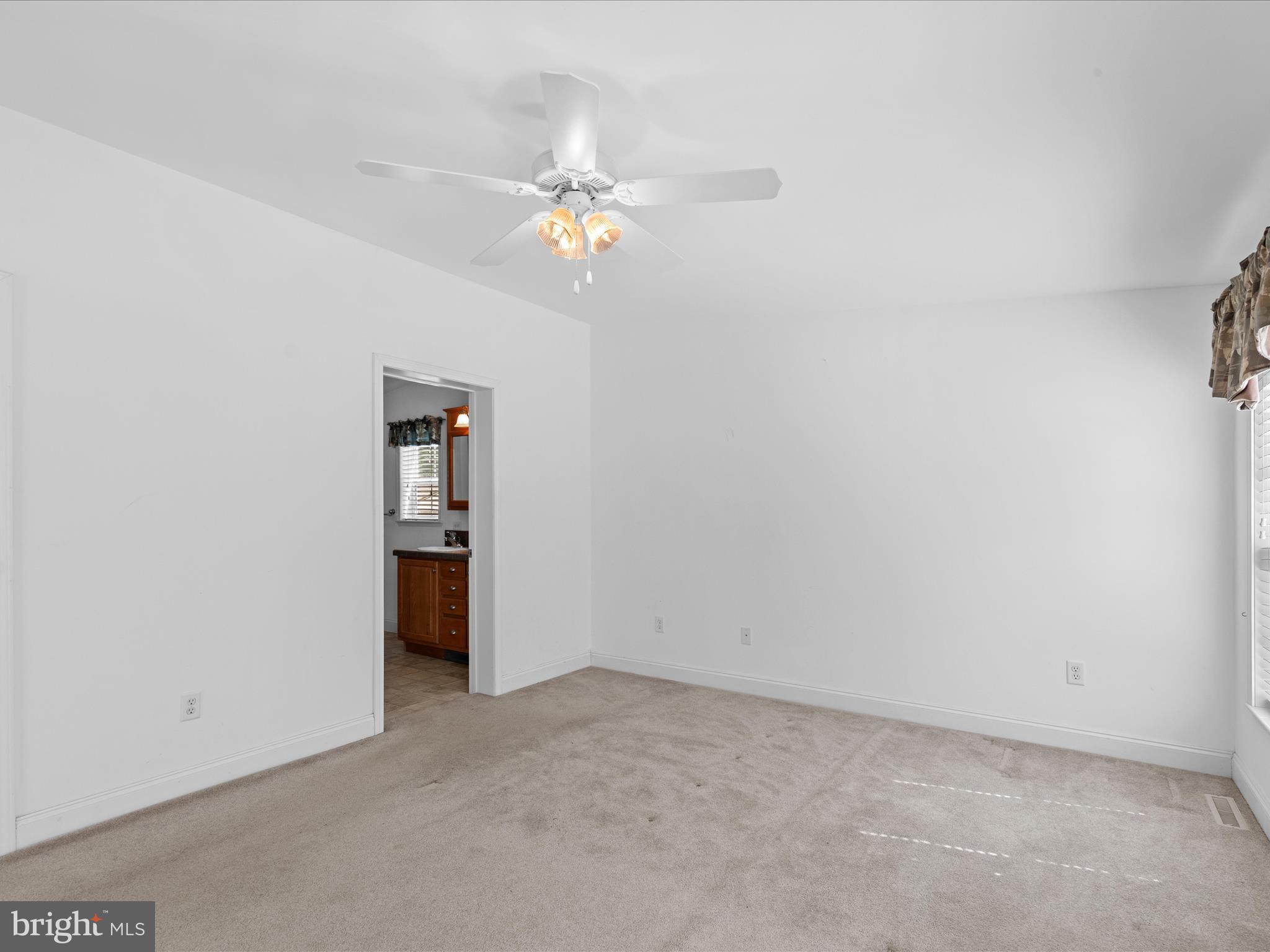 37531 Bonnie Street Ocean View, DE 19970 - Photo 11 of 62 an empty room with a chandelier fan and closet