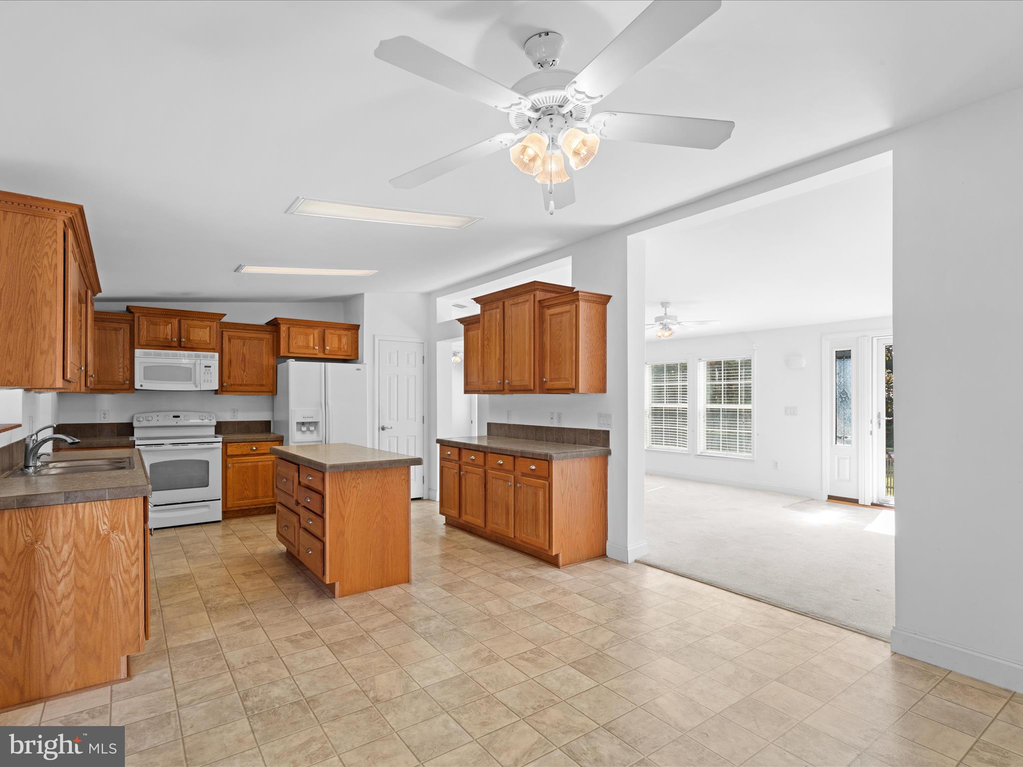 37531 Bonnie Street Ocean View, DE 19970 - Photo 21 of 62 a living room with stainless steel appliances kitchen island granite countertop furniture and a kitchen view