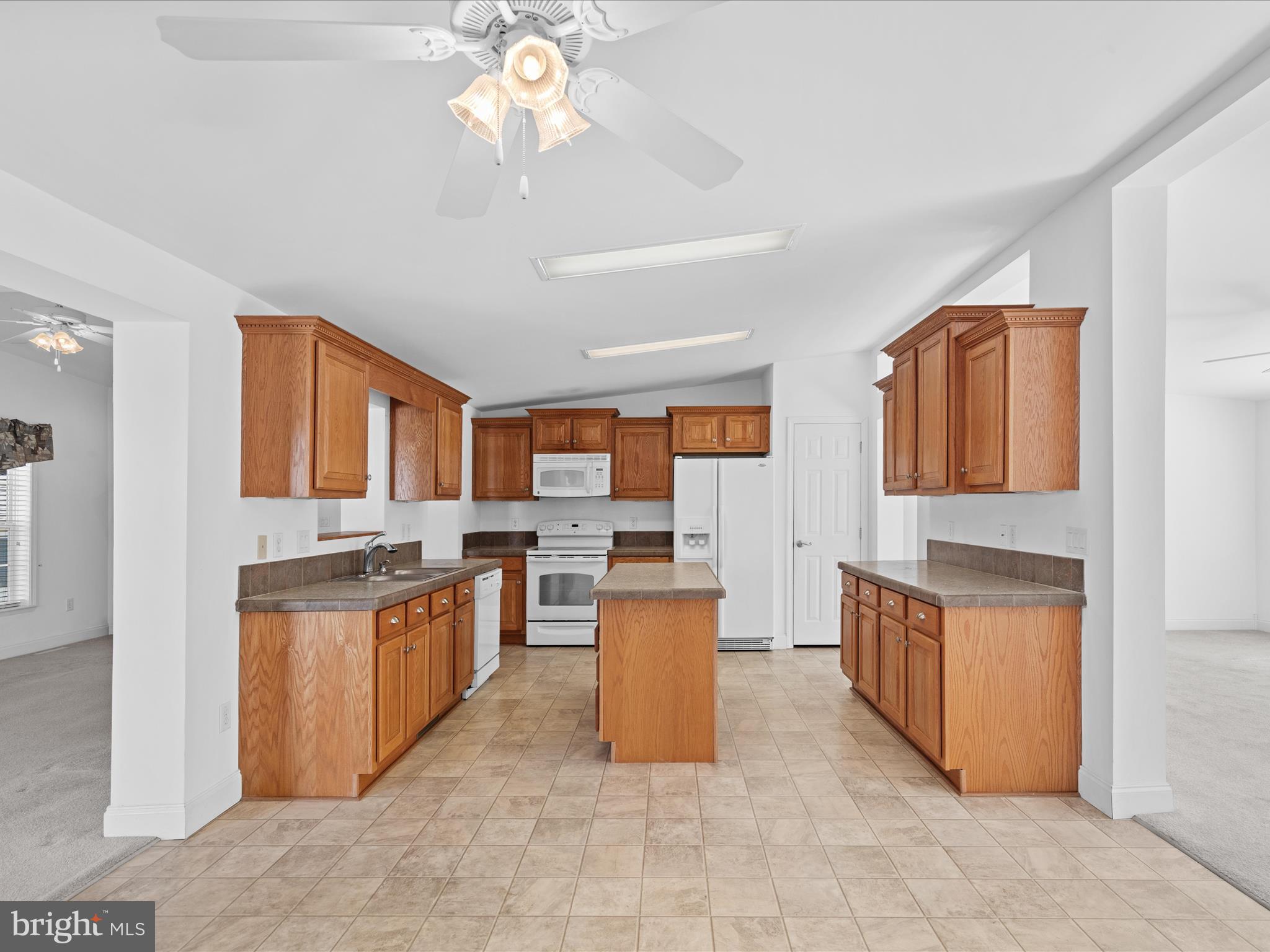 37531 Bonnie Street Ocean View, DE 19970 - Photo 25 of 62 a kitchen with stainless steel appliances granite countertop a stove oven and a refrigerator
