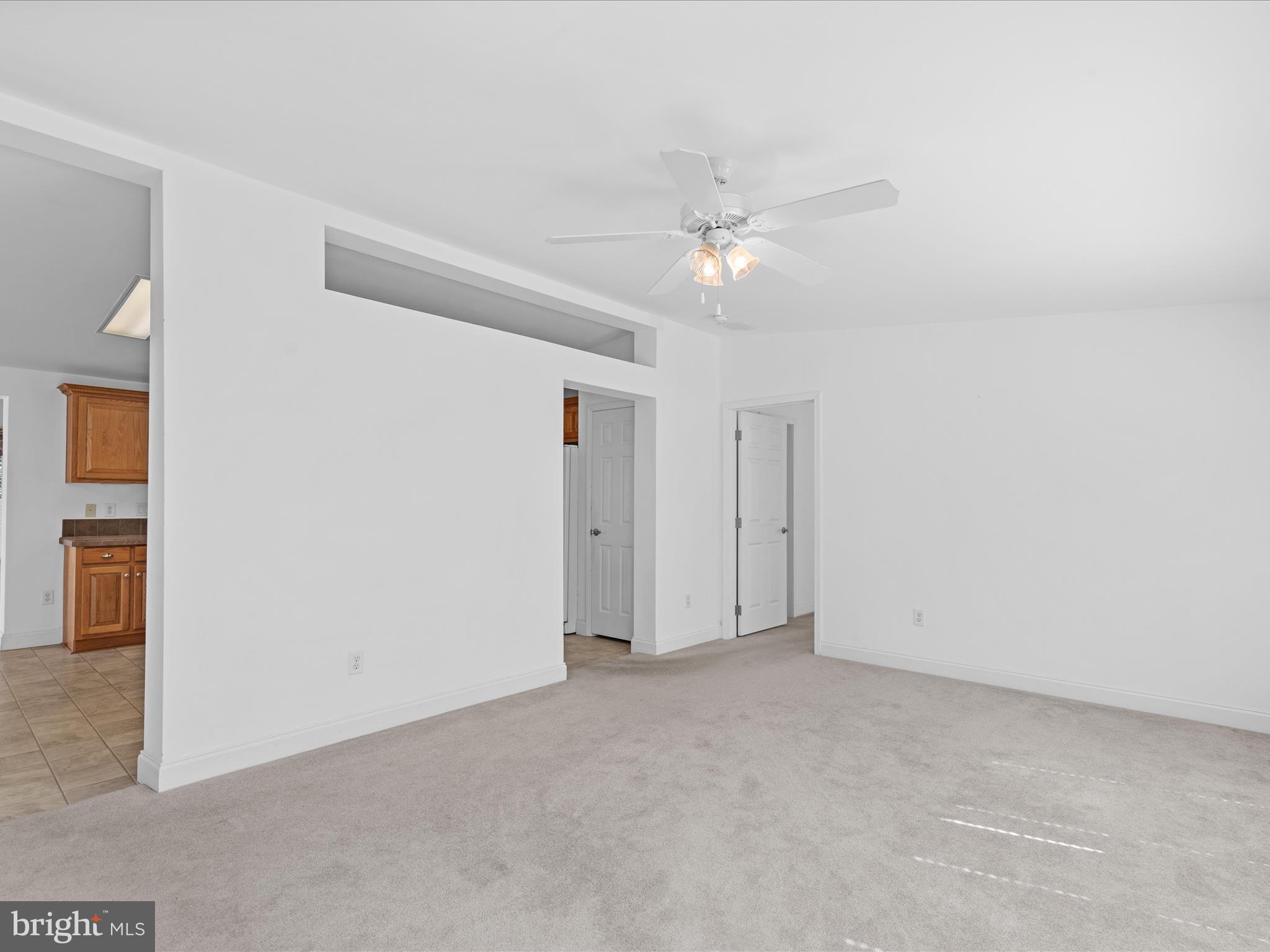 37531 Bonnie Street Ocean View, DE 19970 - Photo 8 of 62 an empty room with a ceiling fan and a window