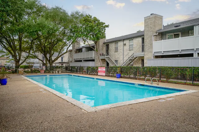 a car parked in front of a white house