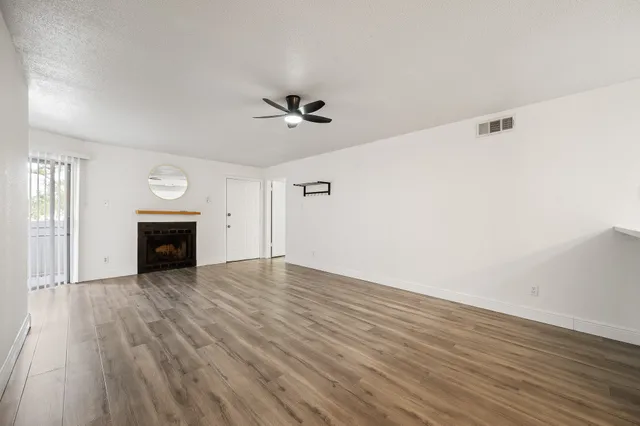 a view of an empty room and wooden floor