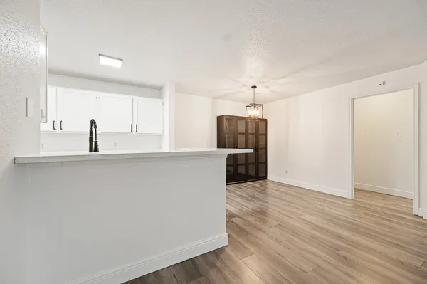 a white toilet sitting next to a bathroom sink and a mirror