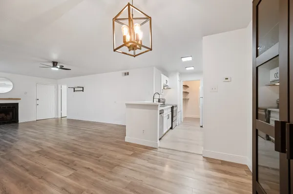 a view of an empty room with wooden floor