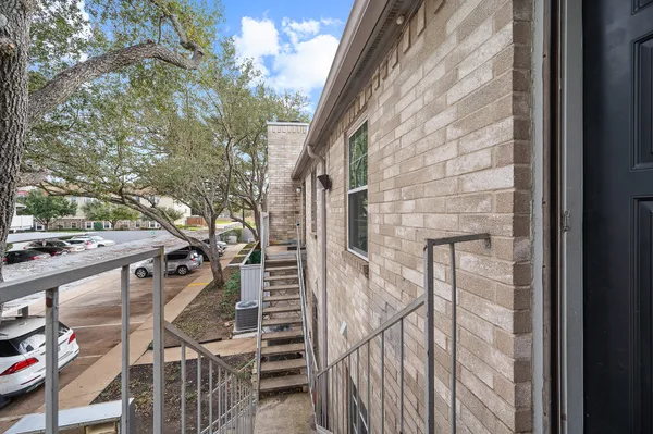 a view of empty room with wooden floor fireplace and windows